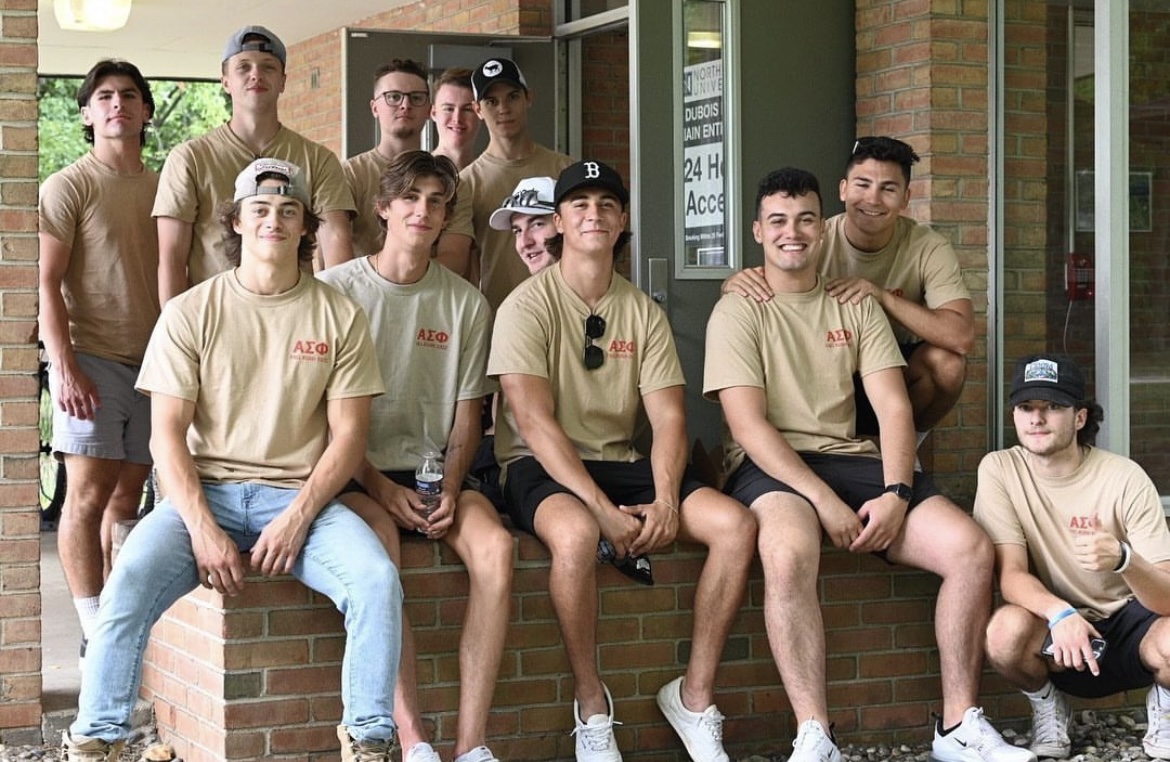 Alpha Sigma pictured together helping freshman on move-in day
