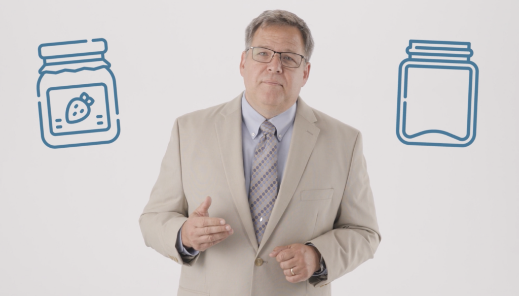 A photo of Dale Matcheck with two cartoon jam jars on either side of him