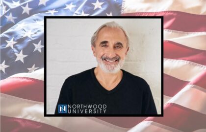 A smiling gray-haired man in a black shirt is pictured in front of a white background. The image is framed over an American flag with a Northwood University logo at the bottom.