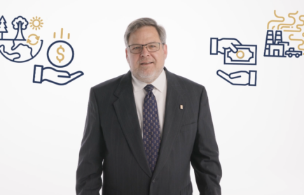 A man in a suit stands between two illustrated graphics: one showing sustainability symbols and a coin, the other showing a hand giving money to factories emitting pollution.
