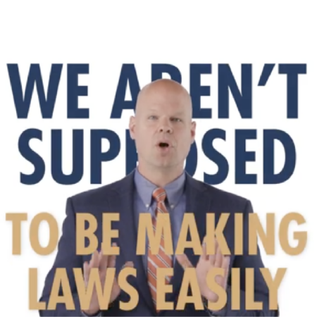 A man in a suit speaks with his hands raised; behind him, large text reads, "WE AREN'T SUPPOSED TO BE MAKING LAWS EASILY," emphasizing the importance of protecting freedom.
