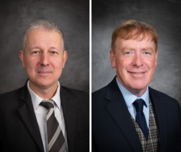 Two middle-aged men in suits, both Professors, pose separately against a gray studio background, facing the camera and smiling mildly—perfect for an Ask the Experts feature on WalletHub.