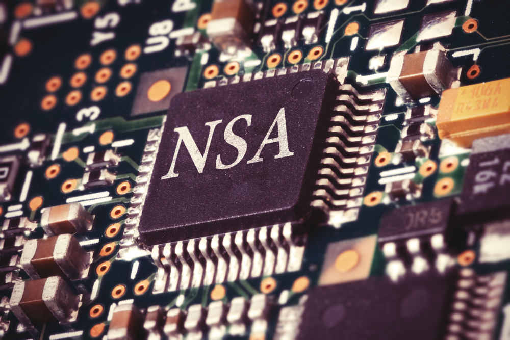 Close-up of a computer circuit board featuring a central chip labeled "NSA," surrounded by electronic components and wiring, highlighting the importance of cybersecurity management.