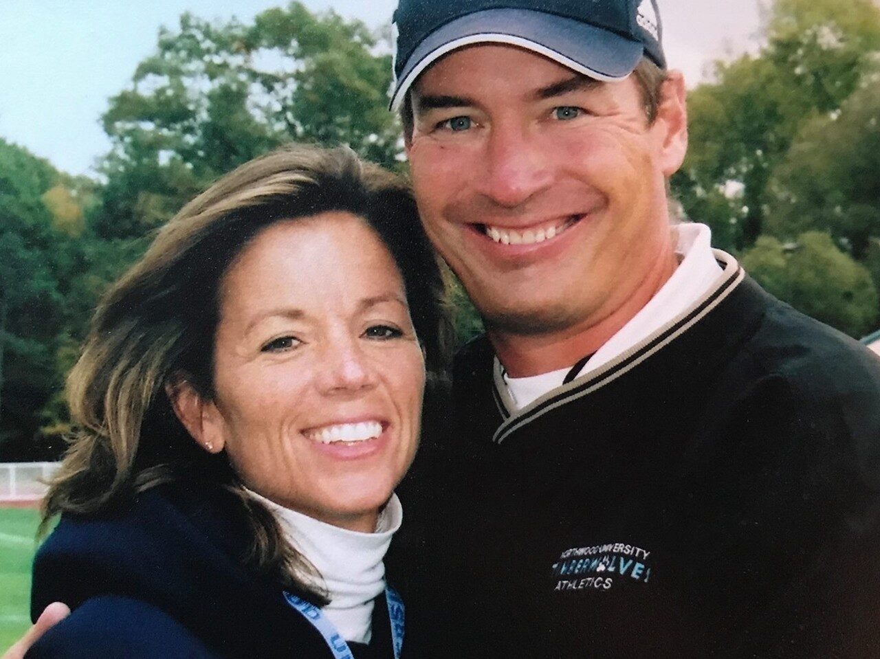 A photo of Pat and Sherri Riepma, wearing Northwood gear and smiling at the camera.