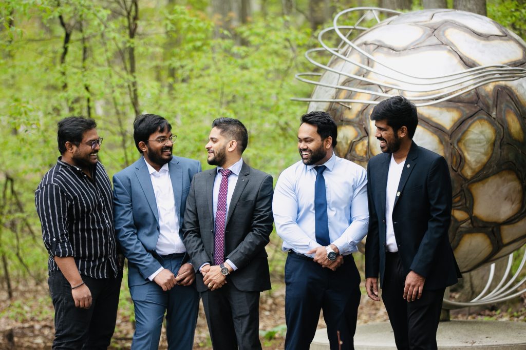 Group of international students posing by the globe on Northwood campus