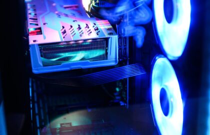 Close-up of a computer case interior showcases illuminated cooling fans and a visible GPU, highlighting the importance of cybersecurity management in maintaining optimal performance.
