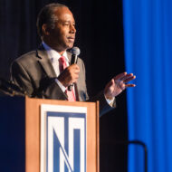 Dr. Benjamin Carson speaking at a podium during the President's Freedom Celebration