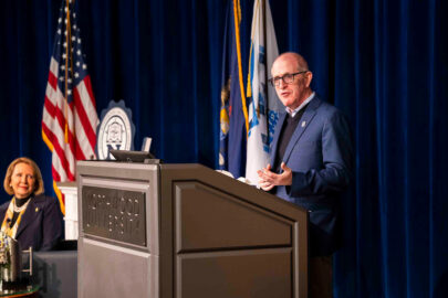 A photo of Dave Oventhal, faculty and endowed chair, speaking at leadership insights on stage behind a podium.