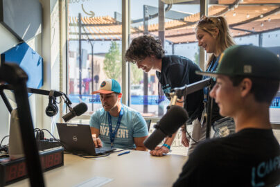 Students sitting in the Idea Center's podcast studio using the equipment.
