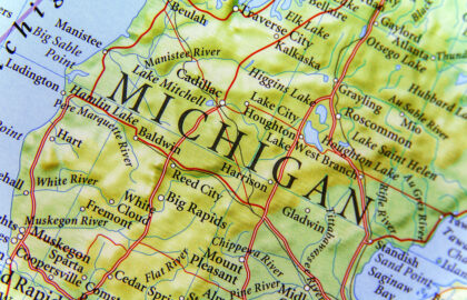 Close-up of a map showing the state of Michigan, including cities, rivers, and highways, with neighboring areas and major geographic features labeled.