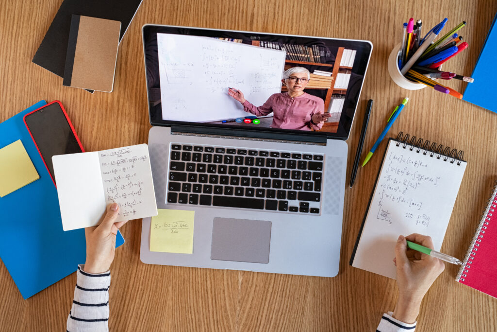High angle view of video conference with teacher on laptop at home.